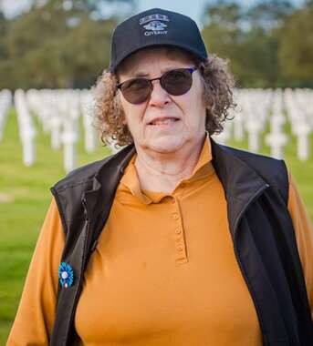 A veteran standing in front of the graves at the Normandy American Cemetery
