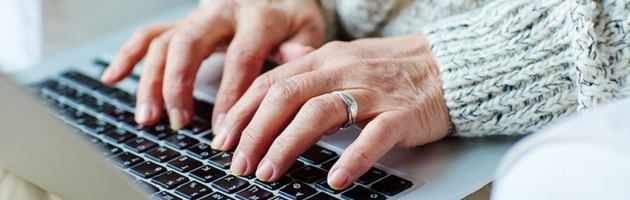 Hands typing on a laptop