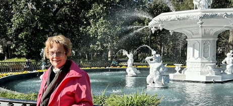 Kathryn stands in front of a white fountain