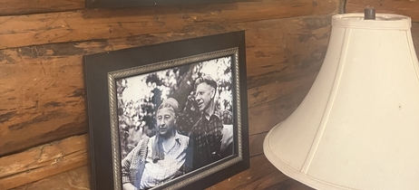 Black and white photos of the Muries line the log cabin walls