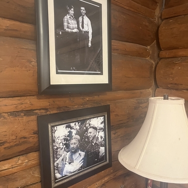 Black and white photos of the Muries line the log cabin walls