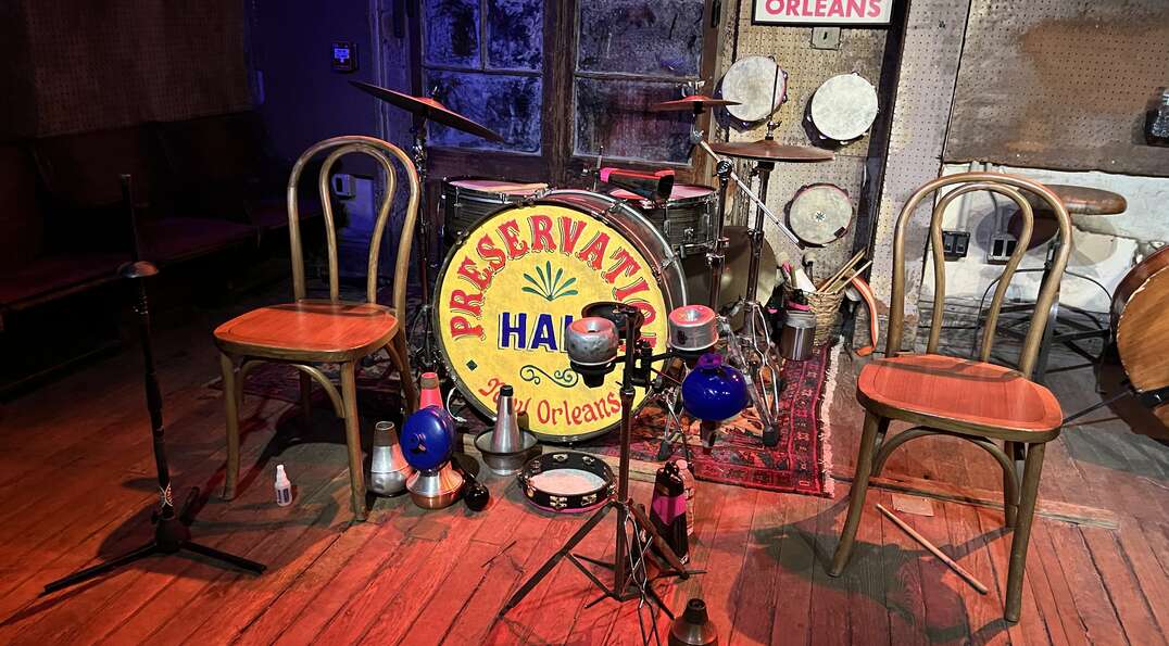 A drum set and chairs sit on stage