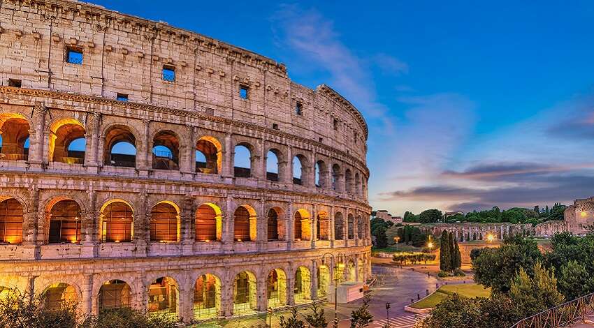 A view of the Colosseum lit up at dusk